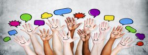 Multi Ethnic People's Hands Raised with Speech Bubble